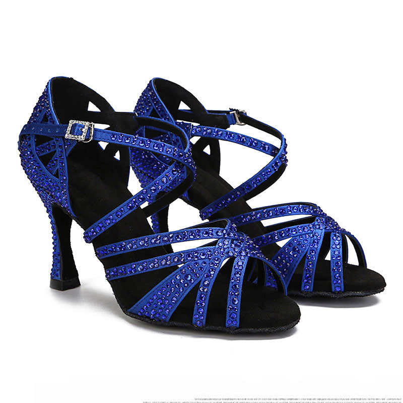 Black and blue strappy high-heeled shoes with rhinestone details on a white background